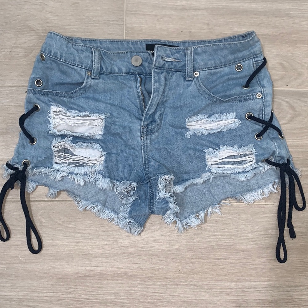 Jean shorts with black strings on the side